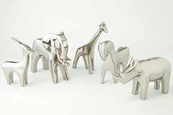 Collection of modern metallic decor figurines including an elephant, giraffe, and rhinoceros, showcasing sleek and reflective surfaces for contemporary interior styling.
